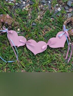 handmade pink wooden heart garland accented with pink and light blue satin bows